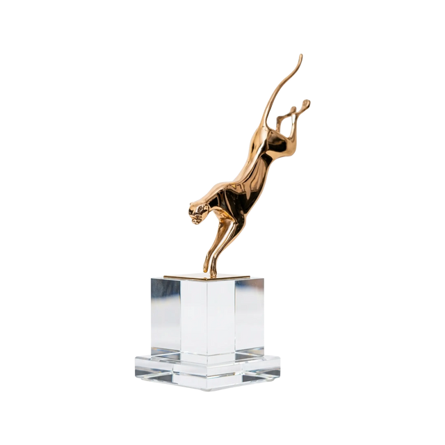 Gold sculpture of a TIGER on a clear crystal base against a white background